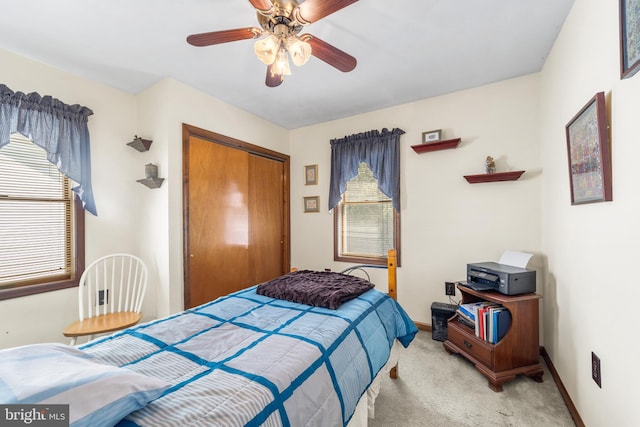 carpeted bedroom featuring a closet and ceiling fan