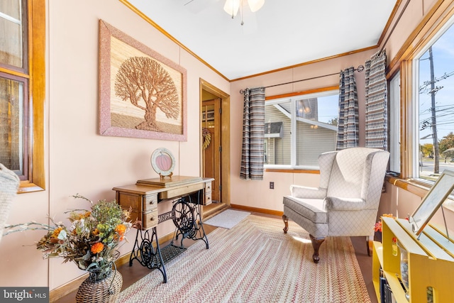 sitting room with light hardwood / wood-style floors, crown molding, and ceiling fan