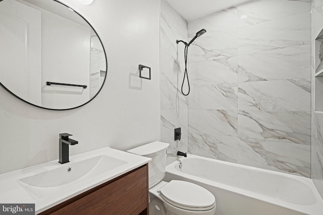 full bathroom with vanity, tiled shower / bath combo, and toilet