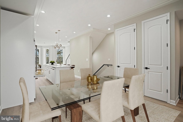 dining space featuring light hardwood / wood-style floors and a notable chandelier