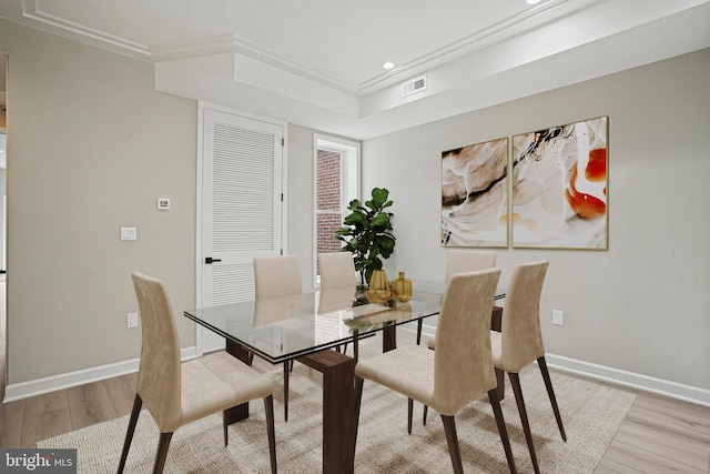 dining room featuring ornamental molding and light hardwood / wood-style flooring