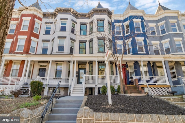 townhome / multi-family property featuring covered porch