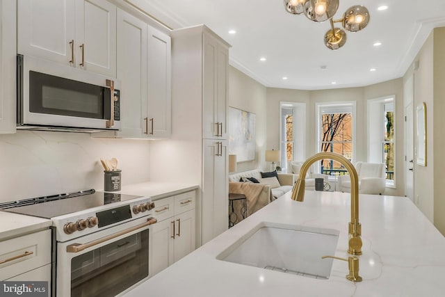 kitchen with electric range, sink, white cabinets, and light stone counters