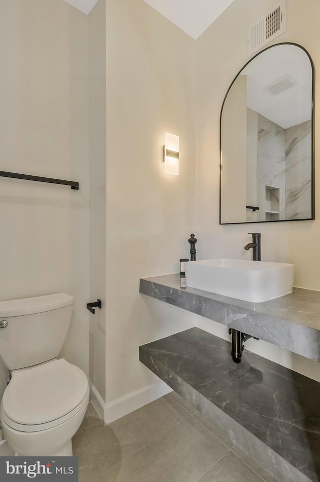 bathroom with tile patterned floors, toilet, and sink