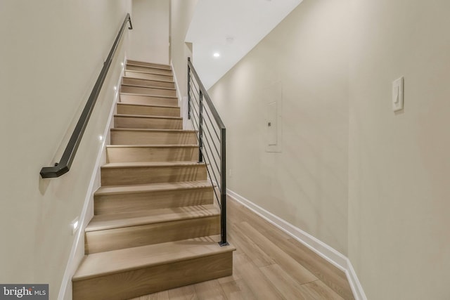 stairway featuring wood-type flooring