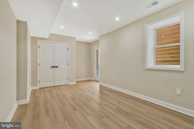 unfurnished bedroom featuring a closet and light hardwood / wood-style flooring