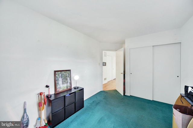 miscellaneous room with dark colored carpet