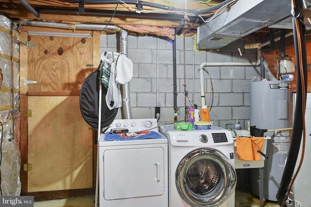 washroom with water heater and independent washer and dryer