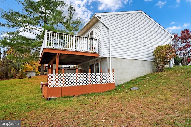 view of side of property featuring a lawn and a wooden deck