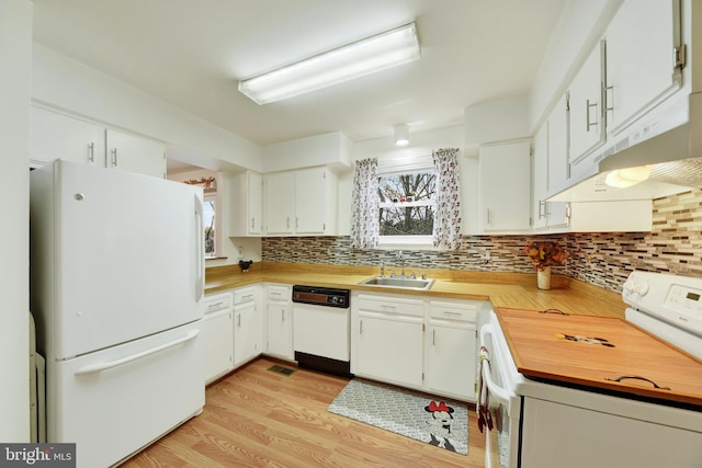 kitchen featuring white cabinets, white appliances, and light wood-type flooring