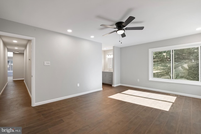 spare room featuring dark wood-type flooring and ceiling fan