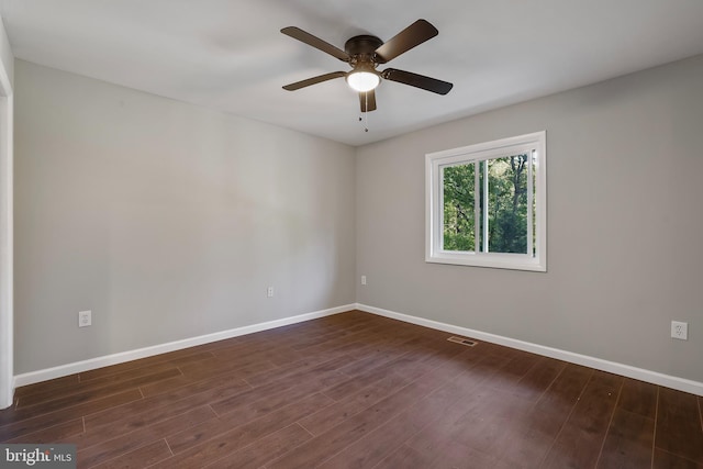 spare room featuring ceiling fan and dark hardwood / wood-style flooring