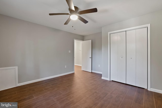 unfurnished bedroom with a closet, dark hardwood / wood-style floors, and ceiling fan