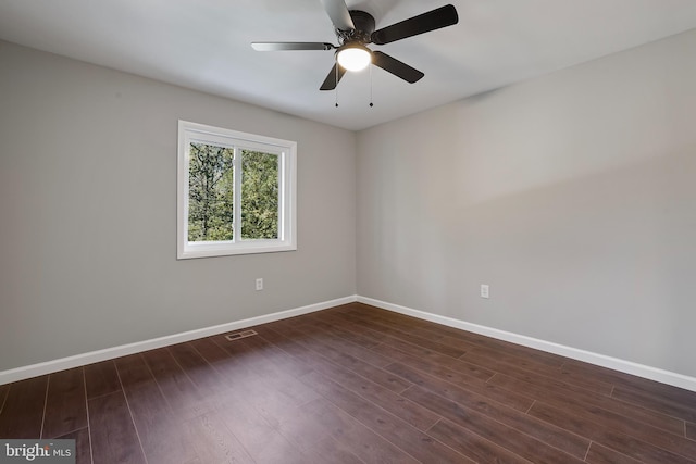 empty room featuring dark wood-type flooring and ceiling fan