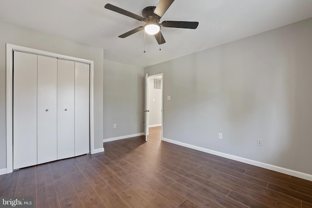 unfurnished bedroom featuring a closet, ceiling fan, and dark hardwood / wood-style flooring