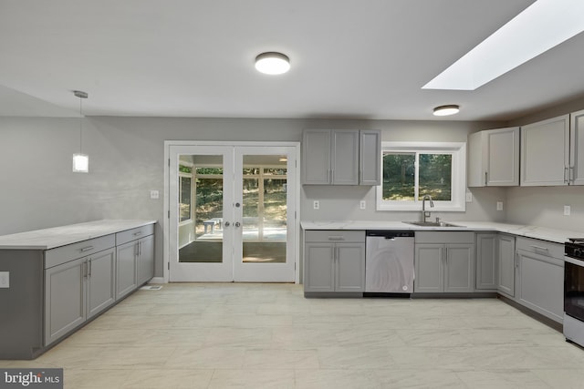 kitchen featuring dishwasher, sink, and gray cabinetry