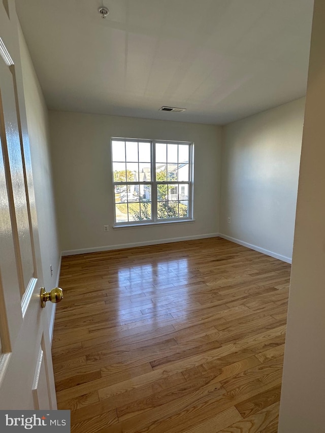 spare room featuring light wood-type flooring