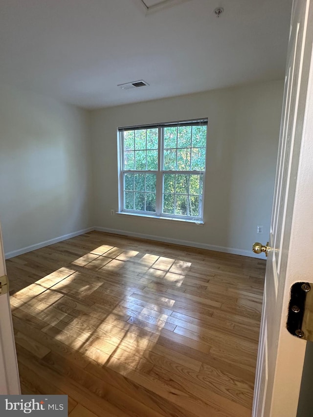 unfurnished room featuring light hardwood / wood-style floors