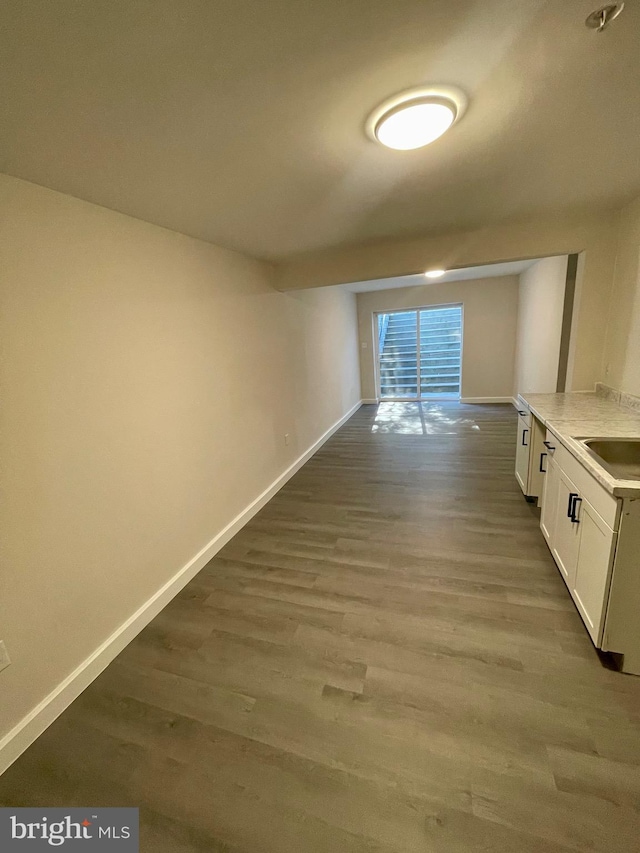 corridor with hardwood / wood-style flooring