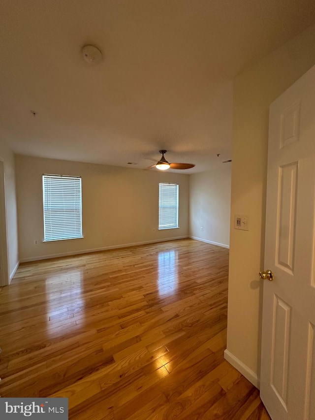 empty room featuring light hardwood / wood-style flooring and ceiling fan