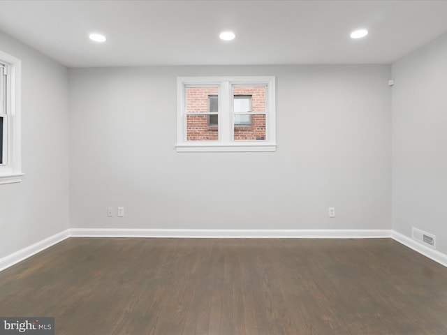 spare room with dark hardwood / wood-style floors