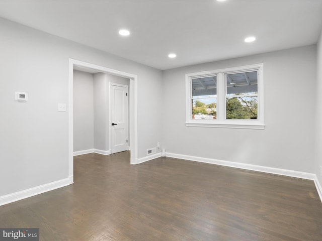 empty room featuring dark wood-type flooring