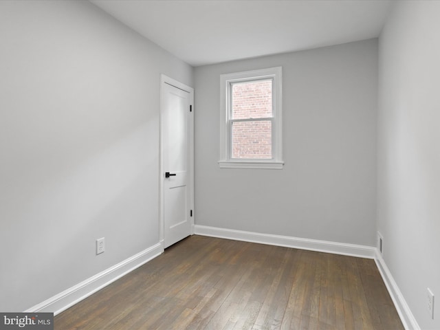 empty room with dark hardwood / wood-style floors