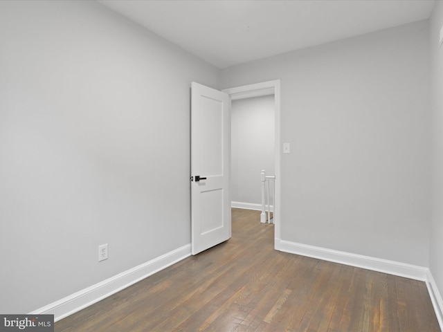 spare room with dark hardwood / wood-style flooring