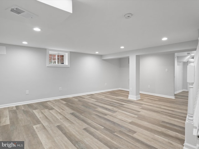 basement with light hardwood / wood-style floors