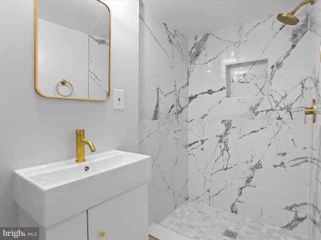 bathroom with vanity and tiled shower