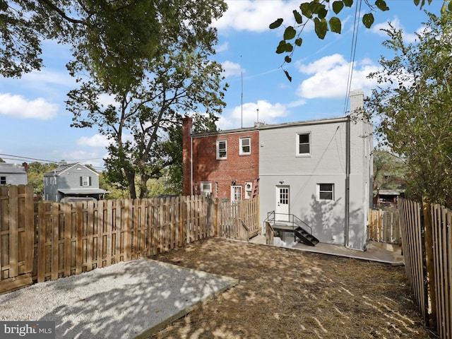 rear view of property featuring a patio area