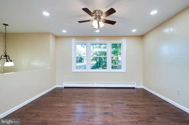 empty room with dark hardwood / wood-style floors, baseboard heating, and ceiling fan