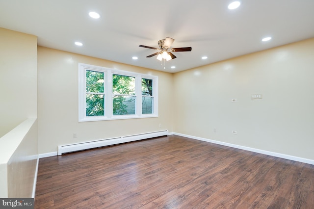 spare room featuring ceiling fan, dark wood-type flooring, and a baseboard radiator