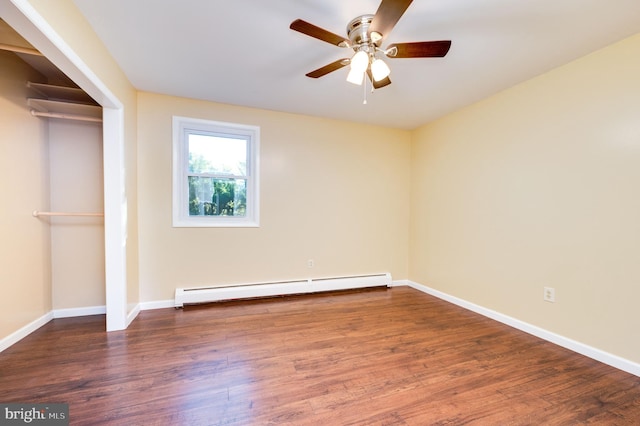 unfurnished room featuring baseboard heating, ceiling fan, and dark hardwood / wood-style flooring