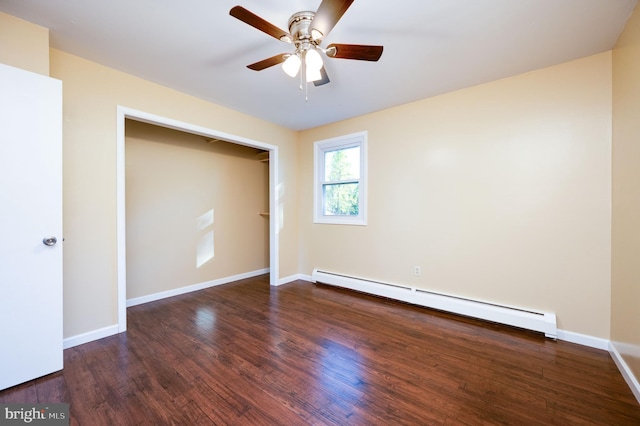 unfurnished bedroom featuring ceiling fan, dark hardwood / wood-style floors, baseboard heating, and a closet