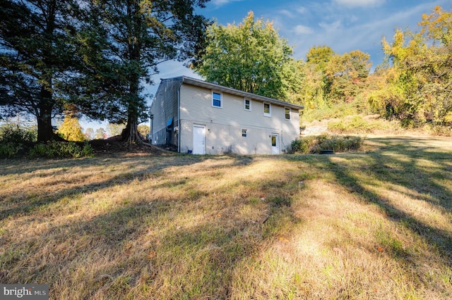 view of property exterior featuring a lawn