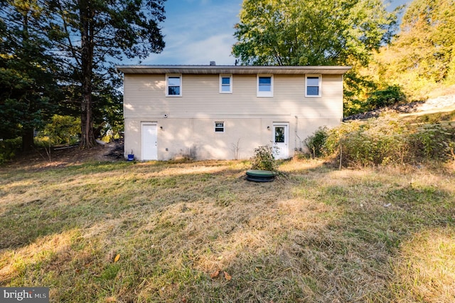 back of house with a lawn