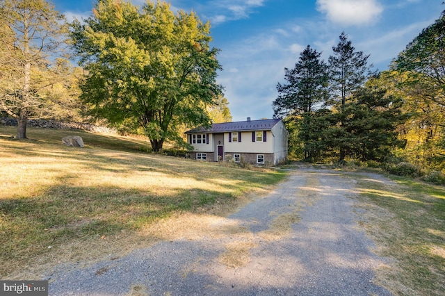 raised ranch with a front yard