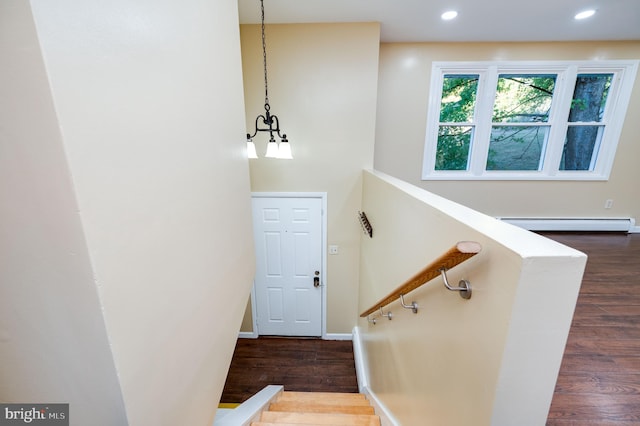 staircase featuring a baseboard radiator and wood-type flooring