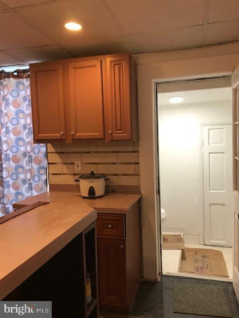 kitchen featuring a paneled ceiling and light countertops