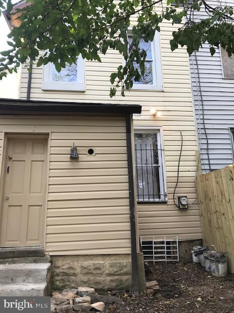 view of home's exterior featuring entry steps and fence