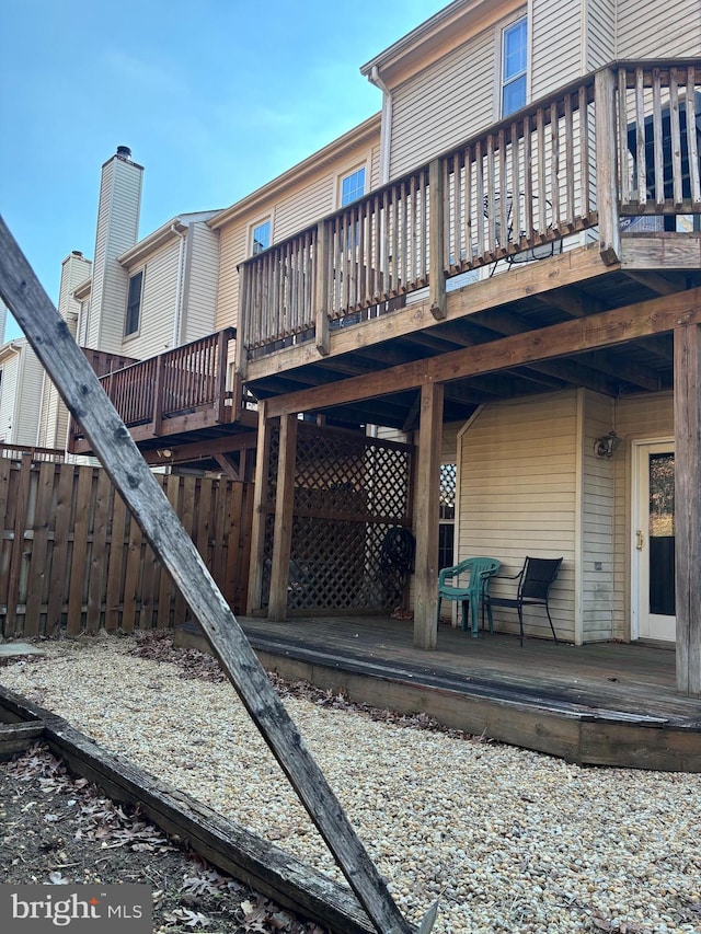 rear view of house featuring a deck