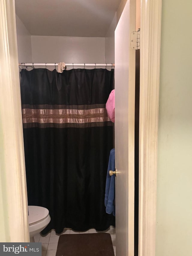 bathroom with tile patterned flooring and toilet