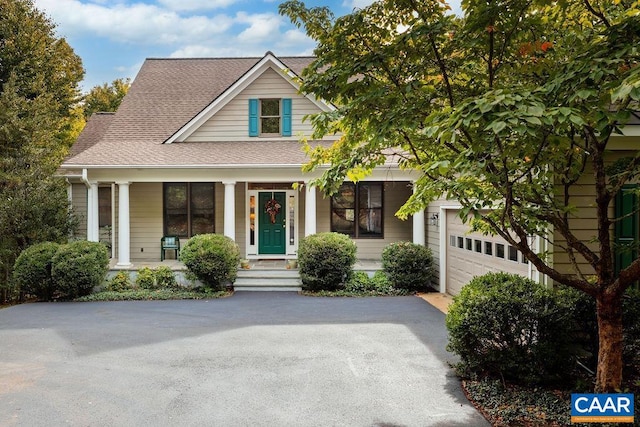 view of front facade with a porch and a garage