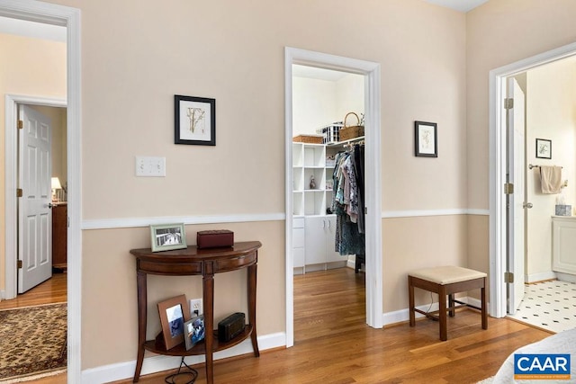 corridor with hardwood / wood-style flooring