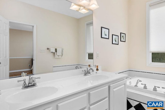 bathroom with vanity and tiled tub