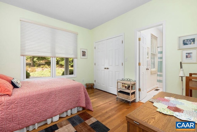 bedroom with light hardwood / wood-style flooring and a closet