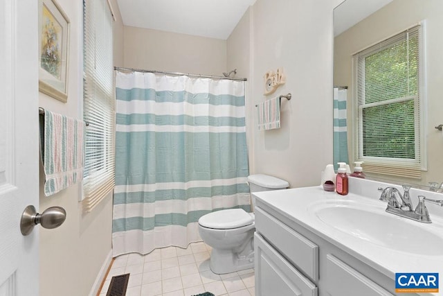 bathroom featuring walk in shower, vanity, toilet, and tile patterned floors