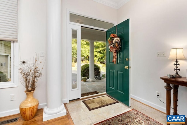 foyer with light hardwood / wood-style flooring and ornamental molding