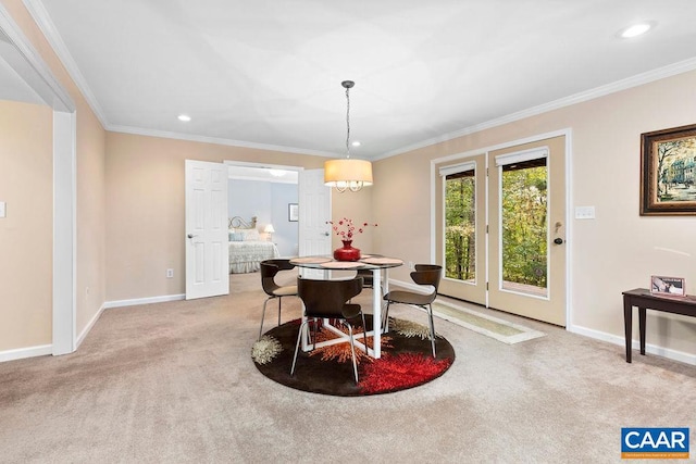 dining area with ornamental molding and light colored carpet